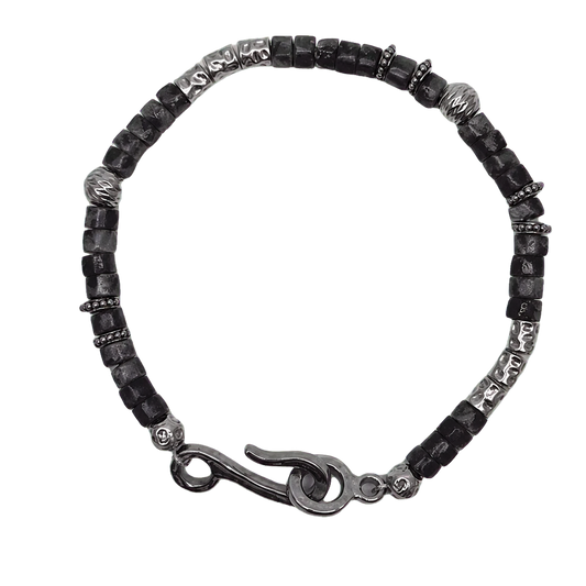 Black-gray beaded bracelet with silver-tone spacers and hook clasp on transparent background