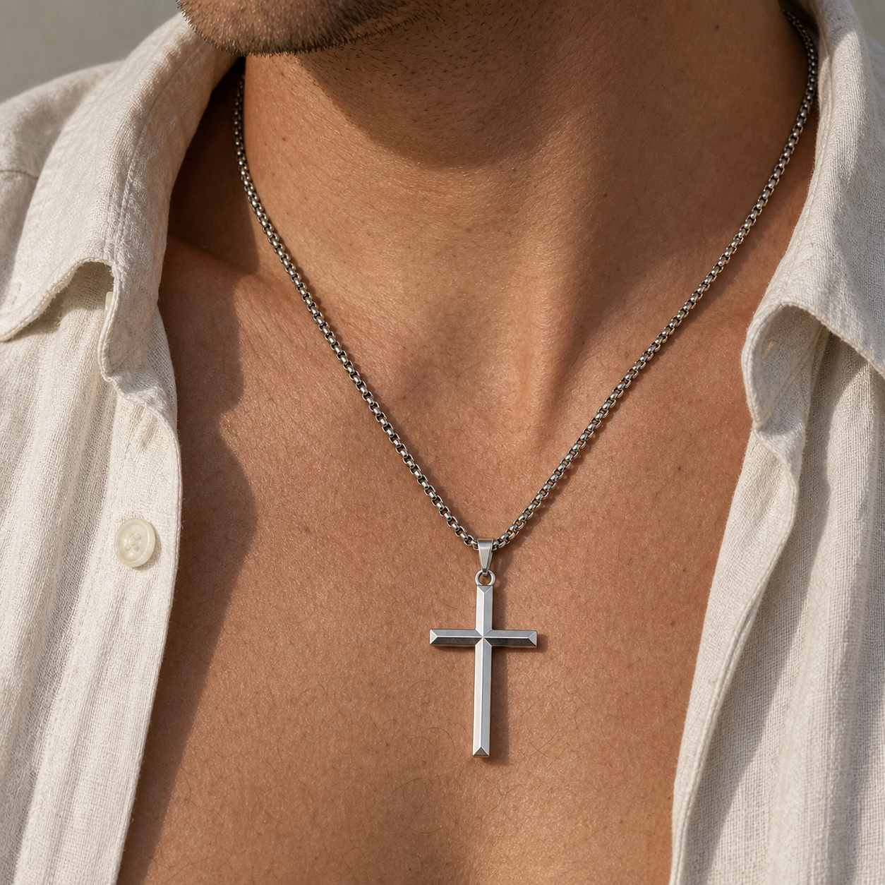 Close wearing detail of titanium faceted cross pendant necklace
